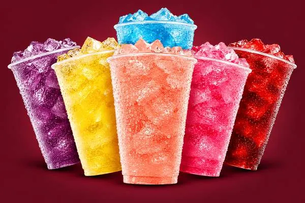 Six colorful iced 7 Fizz sodas in purple, yellow, blue, orange, pink and red