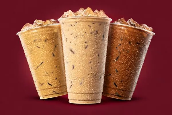 Three iced 7 Originals coffee drinks with caramel and mocha tones