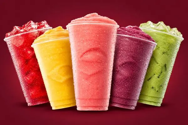 Five frozen 7 Brew smoothies in red, mango yellow, strawberry pink, berry purple and matcha green